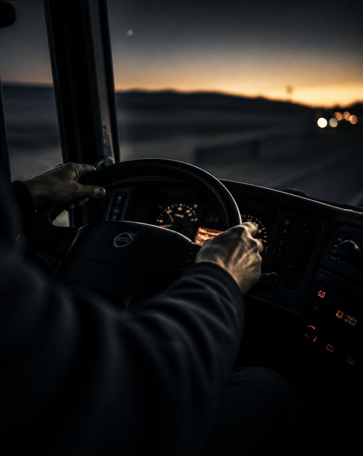 Driver at the wheel of a truck at dawn